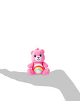 Rainbow bear in the image of a hand to show the small scale.